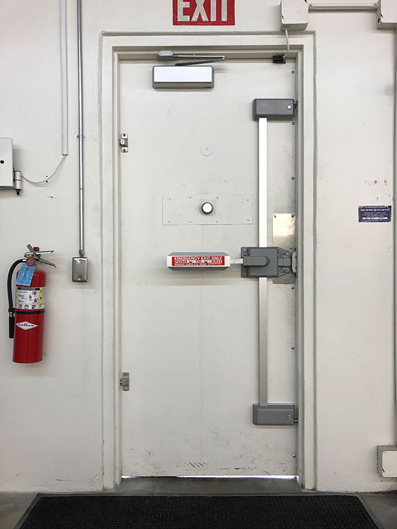 Fire rated door with extinguisher, exit sign, and industrial strength push bar