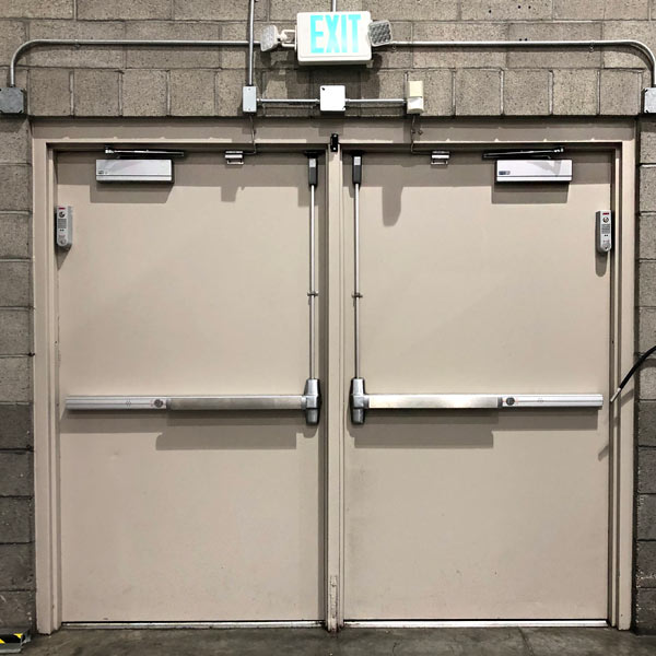 Metal double door with closers and push bars installed in a business in Livermore