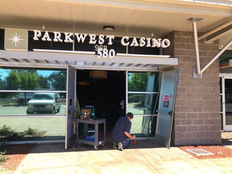 Repairing the storefront door at Parkwest Casino 580 in Livermore, California