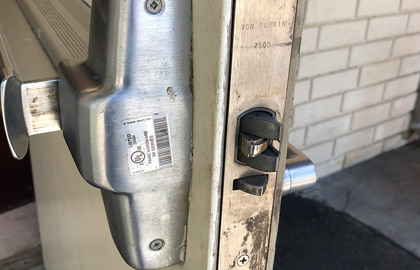 Security door with damaged push bar and locking mechanism