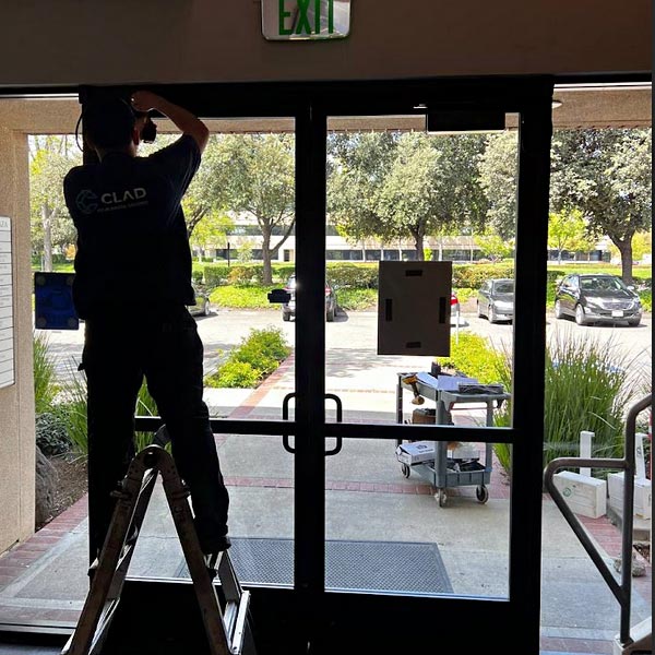 one of our techs is working on a storefront door repair